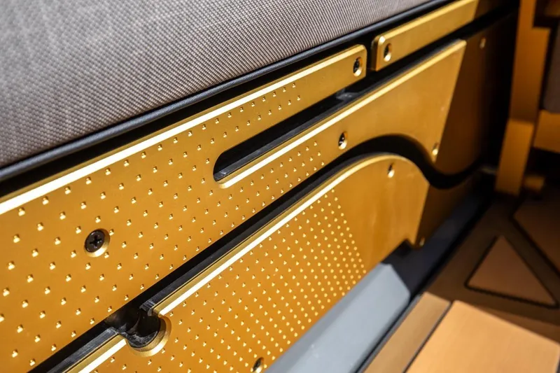 Slide: The Image of 2024 Nautique Super Air Nautique G23 Paragon interior detail with gold accents and textured design. - 15