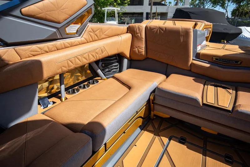 Slide: The Image of Luxurious interior of 2024 Nautique Super Air Nautique G23 Paragon boat with tan upholstery. - 16