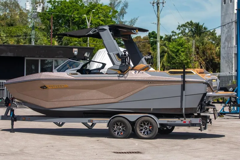 Slide: The Image of 2024 Nautique Super Air Nautique G23 Paragon boat on trailer, outdoor setting. - 36