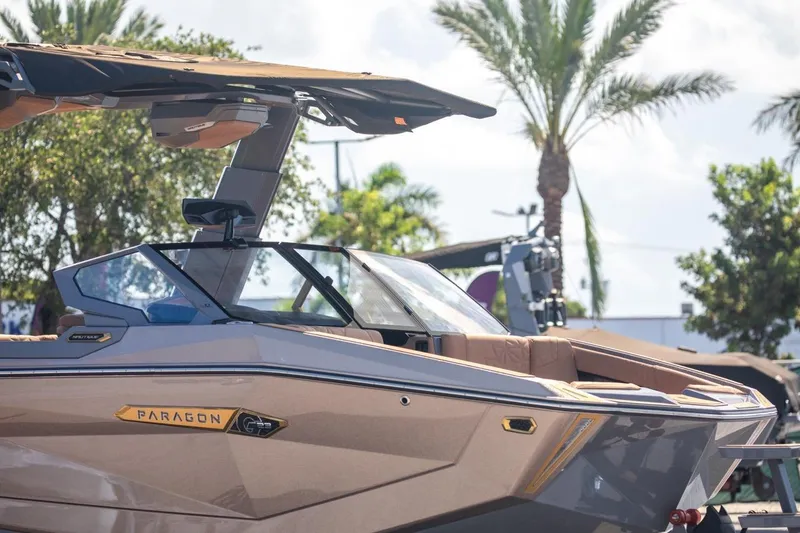 Slide: The Image of 2024 Nautique Super Air Nautique G23 Paragon boat with sleek design and palm trees. - 44