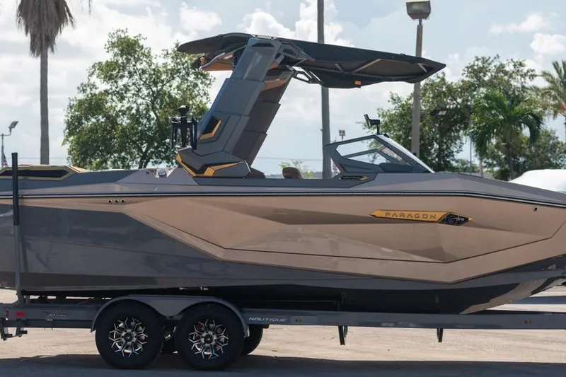 Slide: The Image of 2024 Nautique Super Air Nautique G23 Paragon boat on trailer, sleek design, outdoor setting. - 45