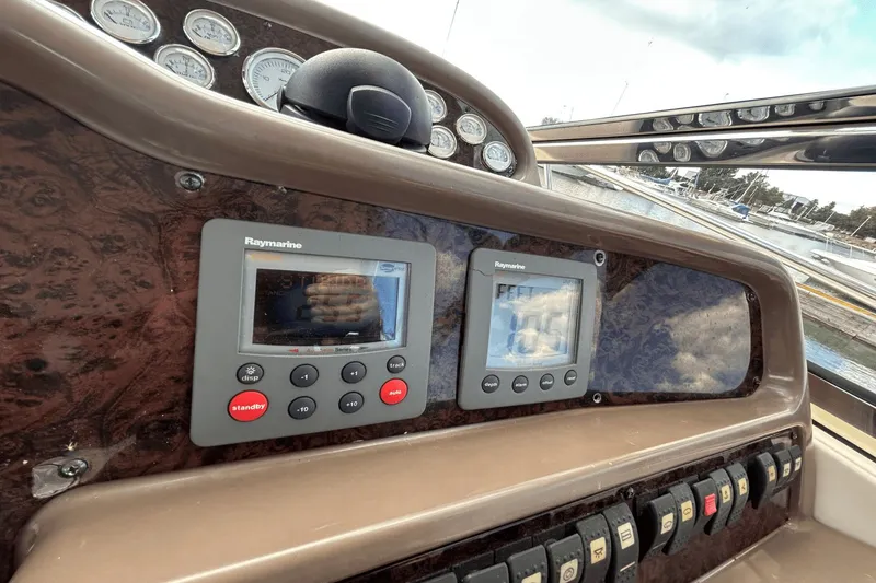Slide: The Image of Control panel of a 2005 Regal Commodore 4260 boat with Raymarine displays. - 11
