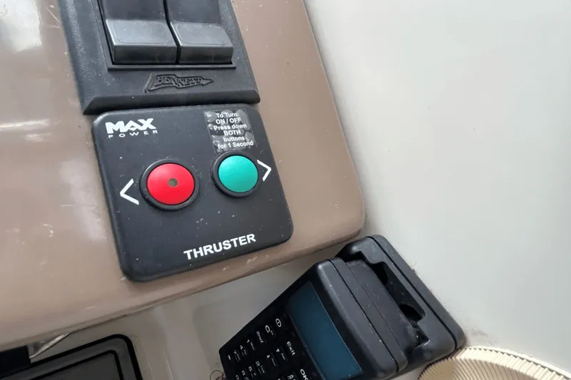 Slide: The Image of Control panel of a 2005 Regal Commodore 4260 boat with thruster buttons. - 14