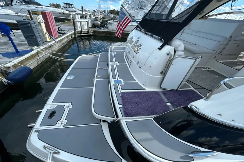 Slide: The Image of 2005 Regal Commodore 4260 yacht docked at marina with American flag. - 2