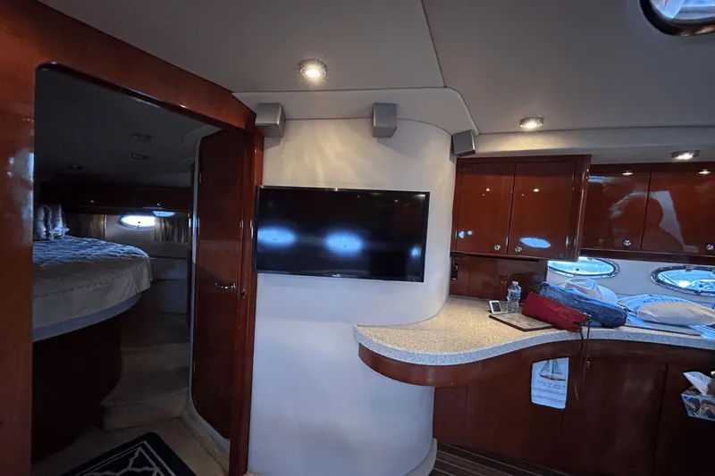Slide: The Image of Luxurious interior of 2005 Regal Commodore 4260 yacht with TV and wooden cabinetry. - 22