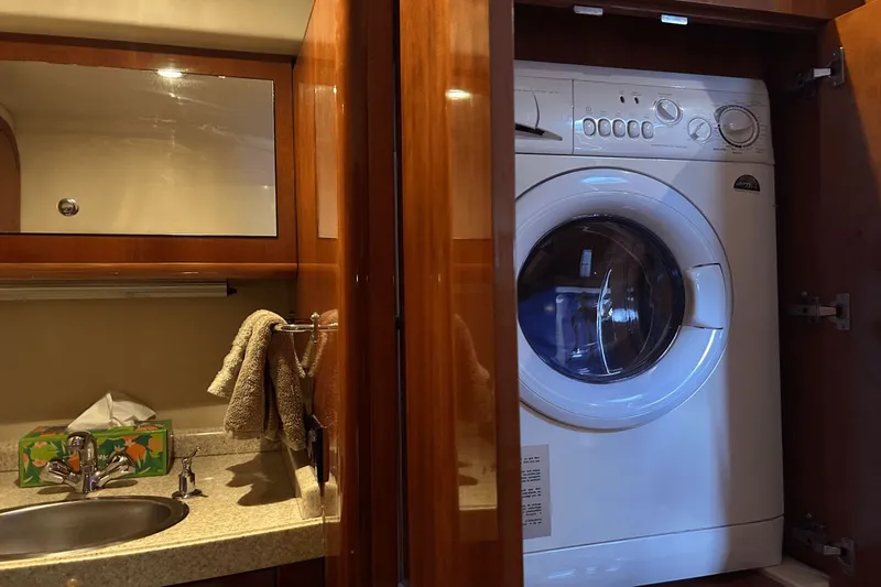 Slide: The Image of Laundry area in 2005 Regal Commodore 4260 yacht with washer and sink. - 30