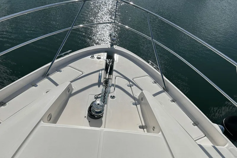 Slide: The Image of Bow of 2005 Regal Commodore 4260 yacht with gleaming water reflection. - 35