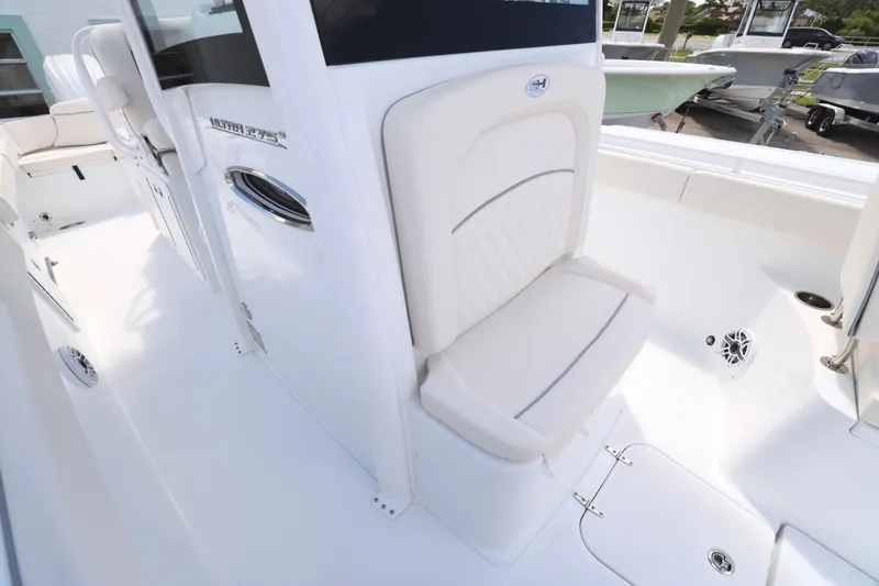 Slide: The Image of 2026 Sea Hunt Ultra 275 SE boat interior with white cushioned seating. - 13
