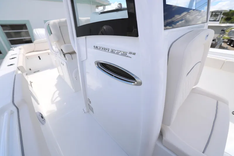 Slide: The Image of 2026 Sea Hunt Ultra 275 SE boat interior with white seating and deck. - 14