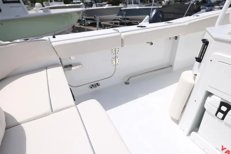 Slide: The Image of 2026 Sea Hunt Ultra 275 SE boat interior with white seating and spacious deck. - 15