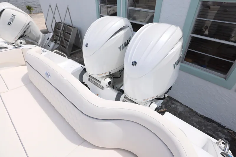 Slide: The Image of 2026 Sea Hunt Ultra 275 SE boat interior with white seating and storage compartments. - 18