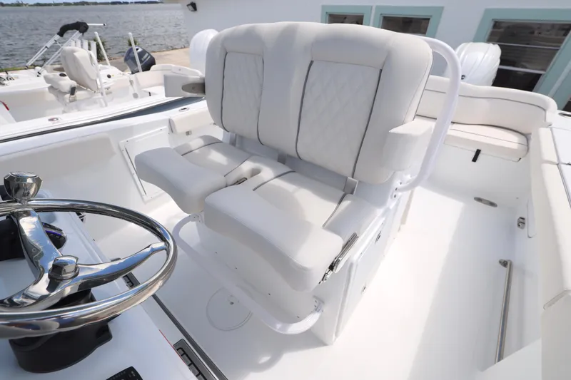 Slide: The Image of 2026 Sea Hunt Ultra 275 SE with dual Yamaha outboard engines, docked near a building. - 20