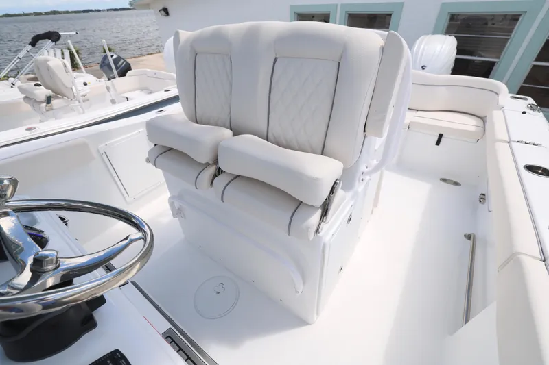 Slide: The Image of 2026 Sea Hunt Ultra 275 SE boat interior with storage drawer and seating. - 21