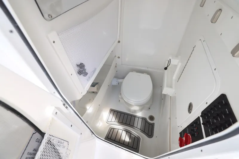 Slide: The Image of 2026 Sea Hunt Ultra 275 SE boat interior with white cushioned seating and steering wheel. - 22