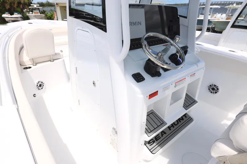 Slide: The Image of 2026 Sea Hunt Ultra 275 SE boat interior with luxurious seating and steering wheel. - 23