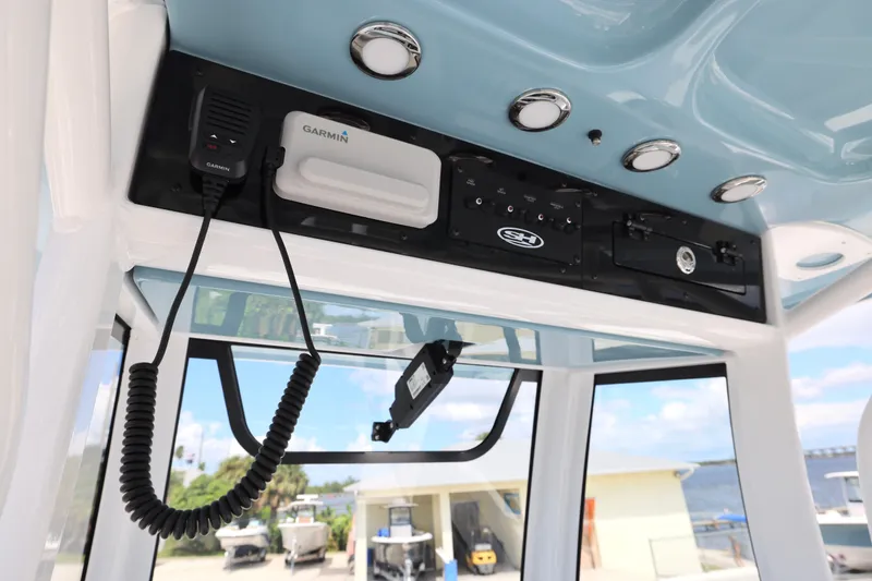 Slide: The Image of 2026 Sea Hunt Ultra 275 SE boat console with steering wheel and Garmin display. - 25