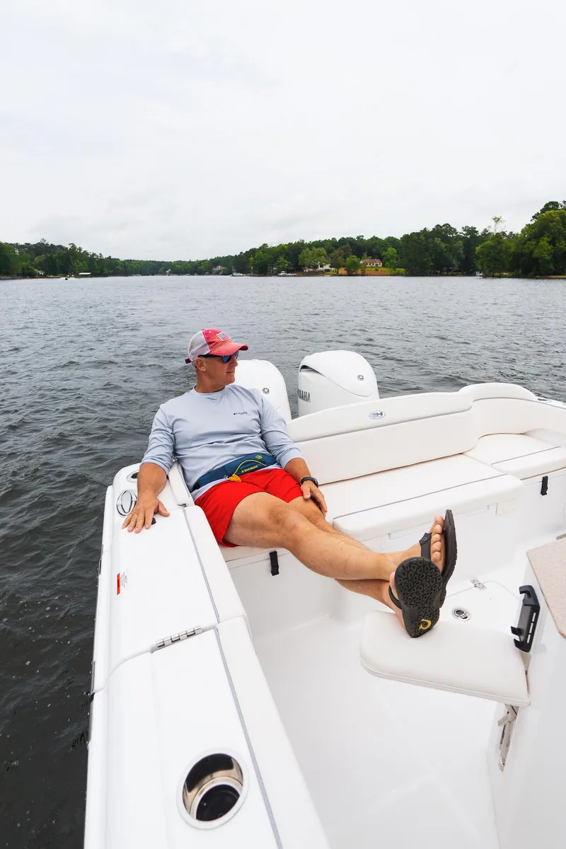 Slide: The Image of 2026 Sea Hunt Ultra 275 SE boat cruising on a lake with trees in the background. - 38