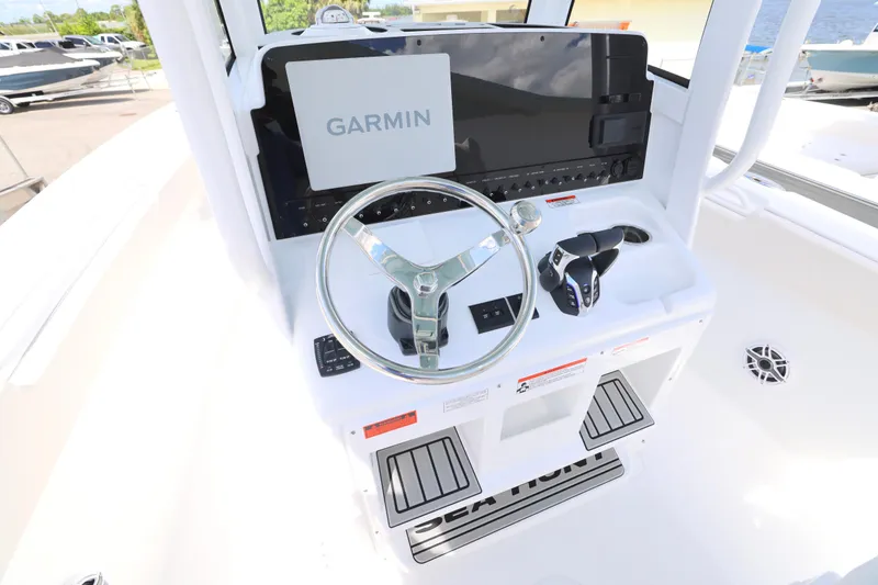 Slide: The Image of 2026 Sea Hunt Ultra 275 SE boat interior with white cushioned seating and Yamaha engines. - 4