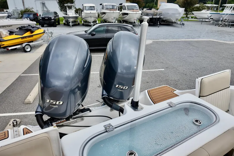 Slide: The Image of 2018 Sea Fox 266 Commander with dual Yamaha 150 engines in a boatyard setting. - 11