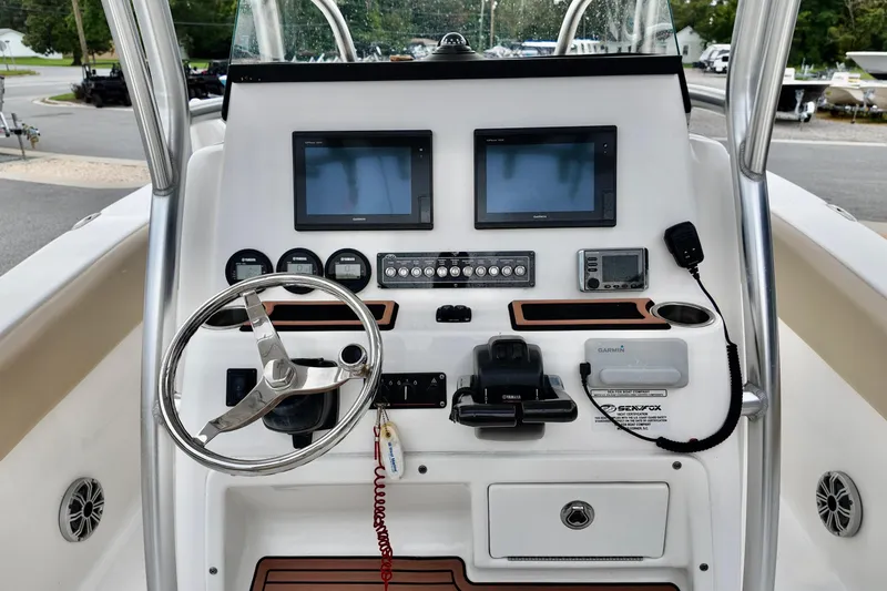 Slide: The Image of 2018 Sea Fox 266 Commander boat dashboard with steering wheel and navigation controls. - 15
