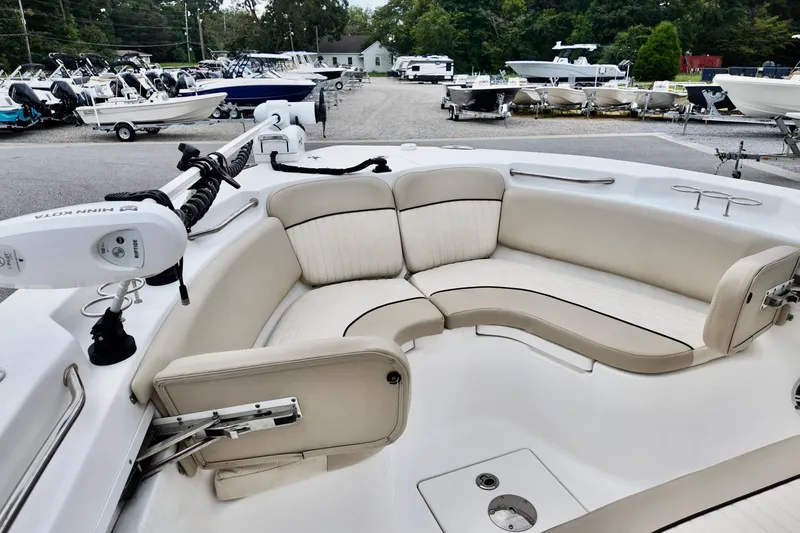Slide: The Image of 2018 Sea Fox 266 Commander boat with spacious seating and modern design in a marina setting. - 18