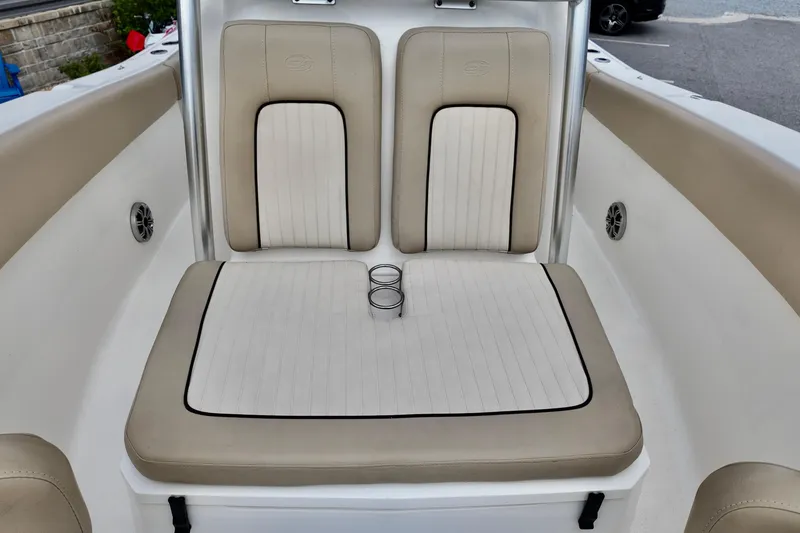 Slide: The Image of 2018 Sea Fox 266 Commander boat seating with cup holders, beige and white upholstery. - 19