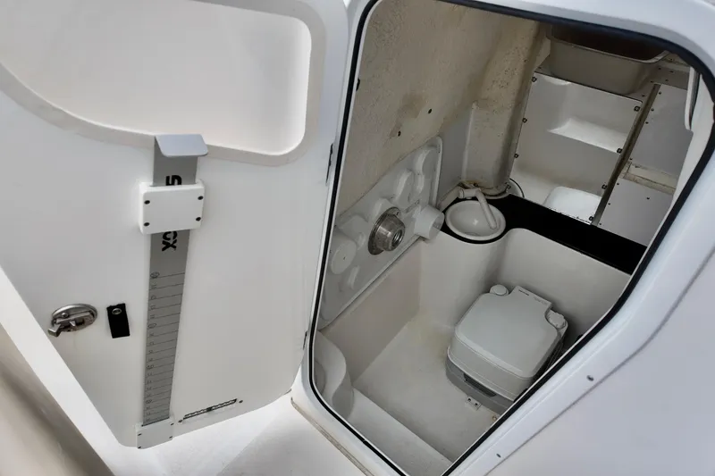 Slide: The Image of 2018 Sea Fox 266 Commander boat interior with compact marine toilet and storage space. - 20