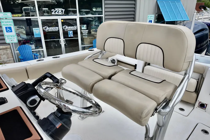 Slide: The Image of 2018 Sea Fox 266 Commander boat interior with beige seating and steering wheel. - 9
