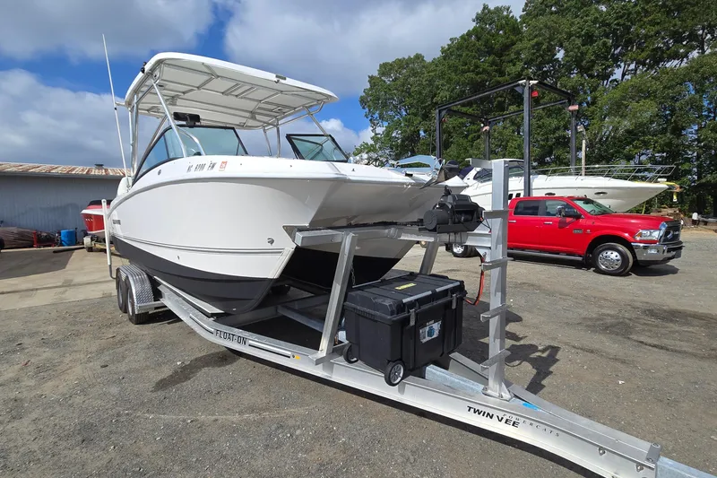 Slide: The Image of 2020 Twin Vee 240 DC GF boat on trailer, parked outdoors. - 1