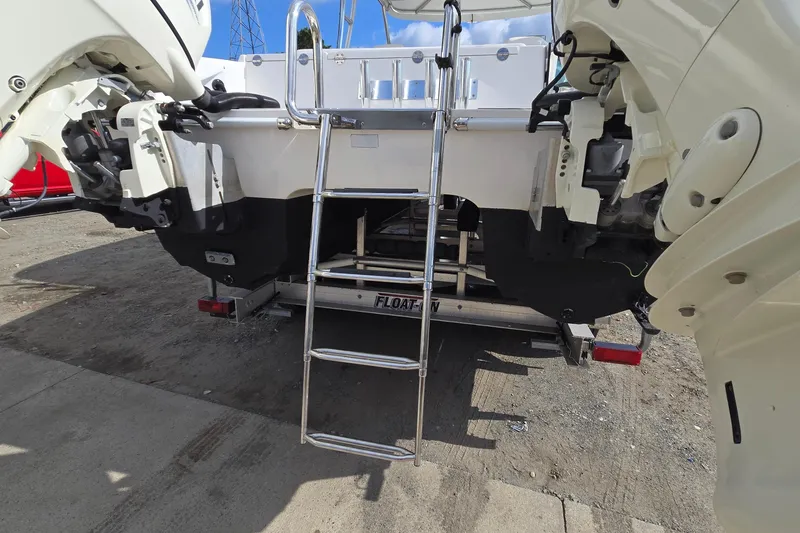 Slide: The Image of 2020 Twin Vee 240 DC GF boat with ladder and dual outboard motors. - 10