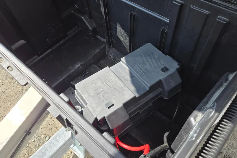 Slide: The Image of Battery compartment of a 2020 Twin Vee 240 DC GF boat with red cable. - 19