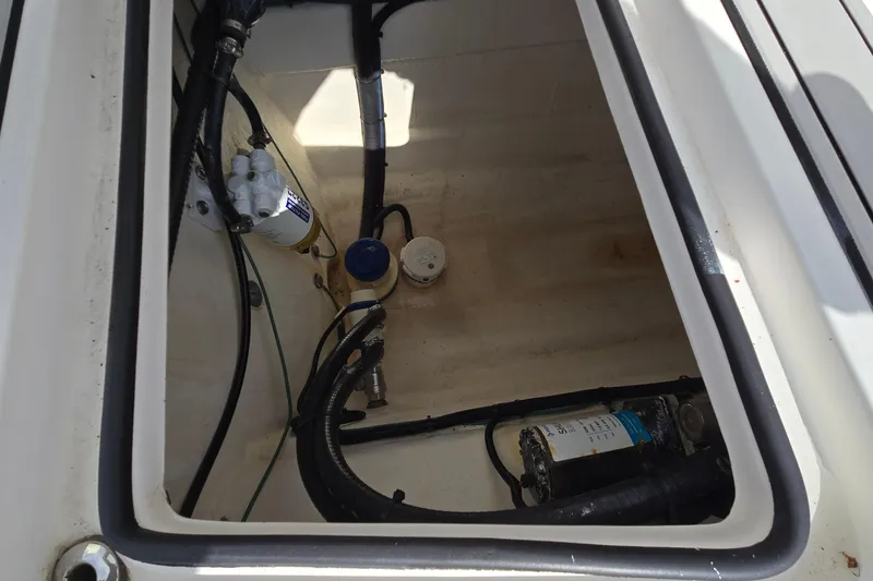 Slide: The Image of 2020 Twin Vee 240 DC GF boat compartment with hoses and equipment. - 21