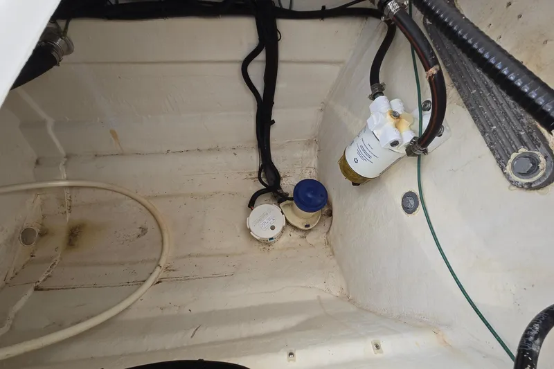 Slide: The Image of Bilge area of a 2020 Twin Vee 240 DC GF boat with visible wiring and components. - 23
