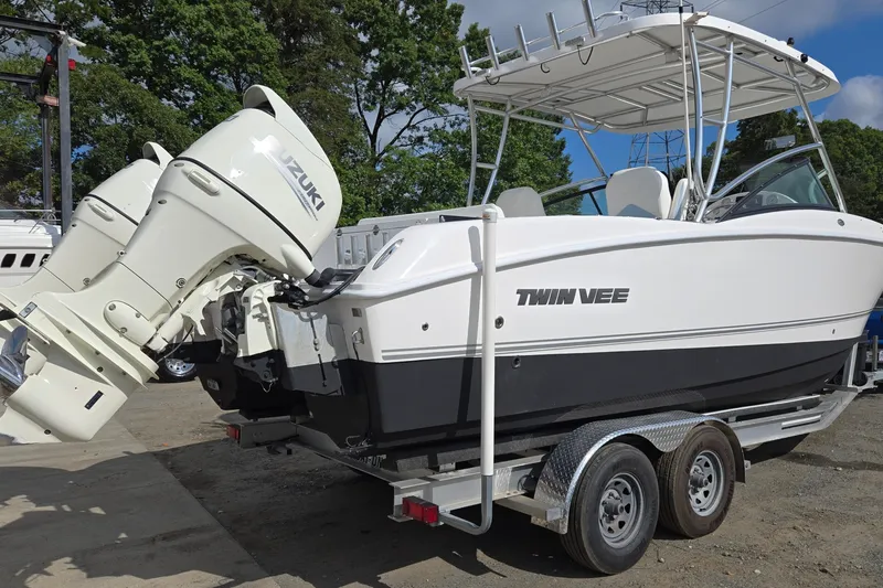 Slide: The Image of 2020 Twin Vee 240 DC GF boat with Suzuki engines on a trailer. - 3