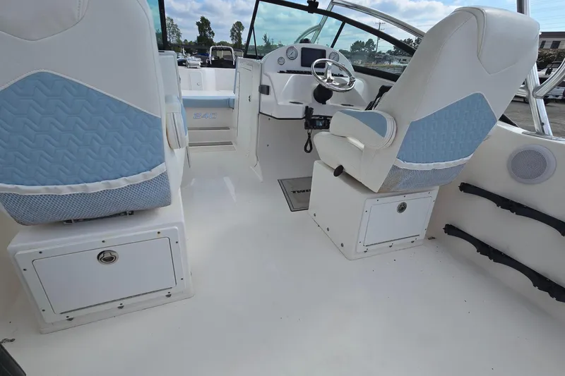 Slide: The Image of 2020 Twin Vee 240 DC GF boat interior with white and blue seating, steering console. - 35
