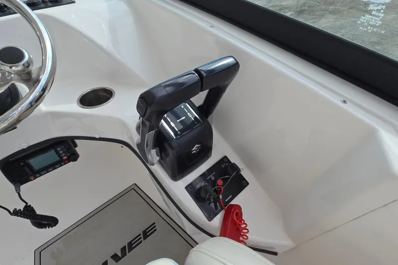 Slide: The Image of 2020 Twin Vee 240 DC GF boat controls with steering wheel and throttle lever. - 37