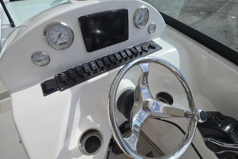 Slide: The Image of Steering console of 2020 Twin Vee 240 DC GF boat with gauges and controls. - 38