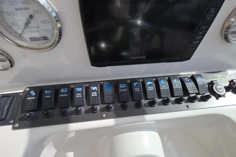 Slide: The Image of 2020 Twin Vee 240 DC GF dashboard with switches and Garmin display. - 39