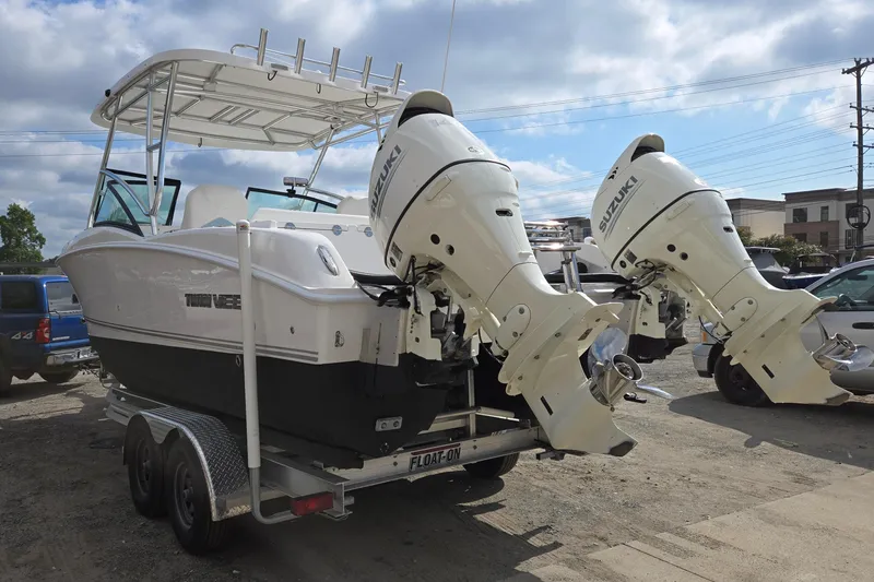 Slide: The Image of 2020 Twin Vee 240 DC GF boat with dual Suzuki outboard motors on a trailer. - 4