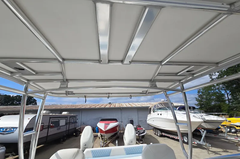 Slide: The Image of 2020 Twin Vee 240 DC GF boat interior view with canopy and surrounding boats. - 42