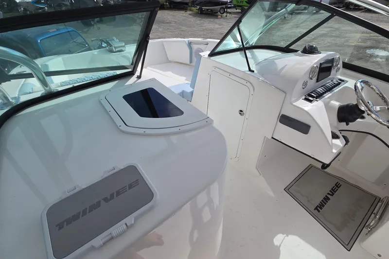 Slide: The Image of 2020 Twin Vee 240 DC GF boat interior with steering console and seating area. - 44