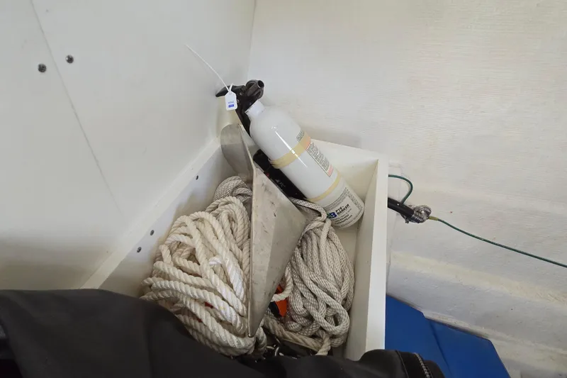 Slide: The Image of Storage compartment with rope, fire extinguisher, and anchor on a 2020 Twin Vee 240 DC GF boat. - 50