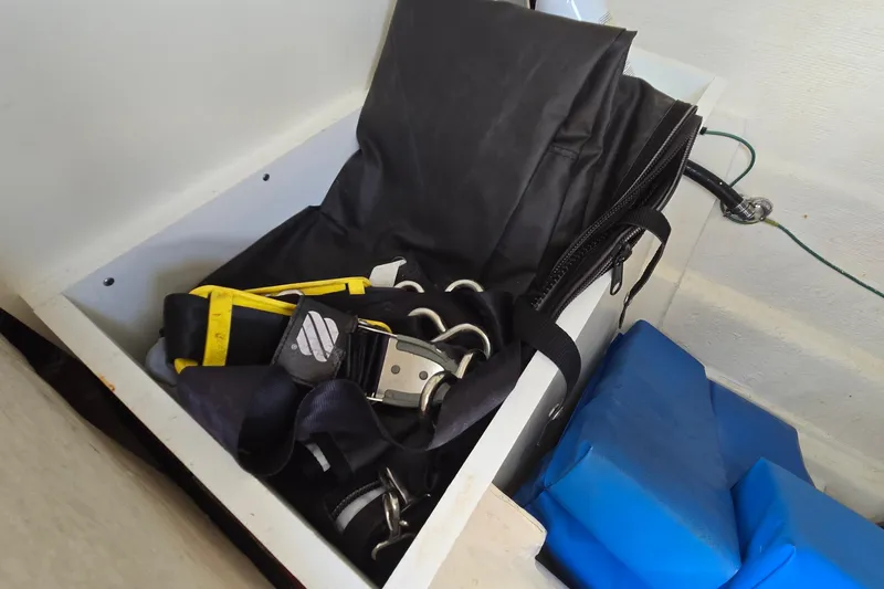 Slide: The Image of Storage compartment in a 2020 Twin Vee 240 DC GF boat with safety equipment. - 51