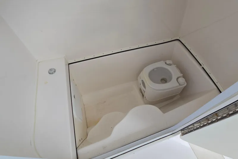Slide: The Image of 2020 Twin Vee 240 DC GF boat interior with compact marine toilet. - 55