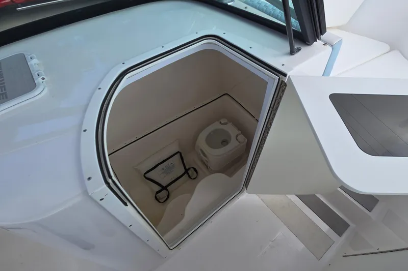 Slide: The Image of 2020 Twin Vee 240 DC GF boat interior with compact marine toilet. - 57