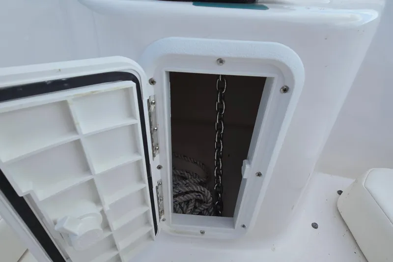 Slide: The Image of Open storage compartment with chain and rope on a 2020 Twin Vee 240 DC GF boat. - 60