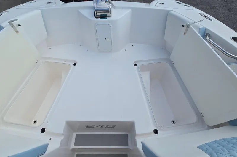 Slide: The Image of 2020 Twin Vee 240 DC GF boat interior with storage compartments and seating. - 65