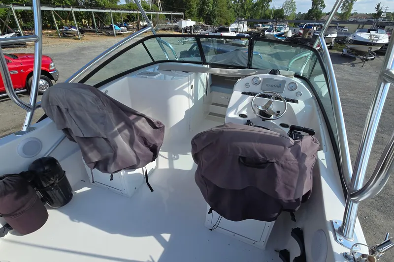 Slide: The Image of 2020 Twin Vee 240 DC GF boat interior with covered seats and steering console. - 67