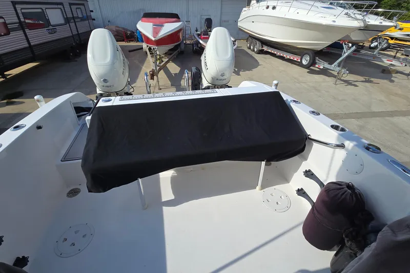 Slide: The Image of 2020 Twin Vee 240 DC GF boat with dual outboard motors in a marina setting. - 68