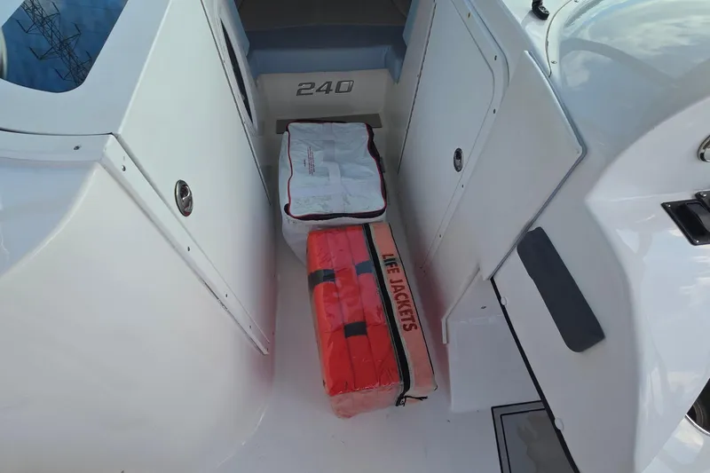 Slide: The Image of 2020 Twin Vee 240 DC GF boat storage area with life jackets and cushions. - 69
